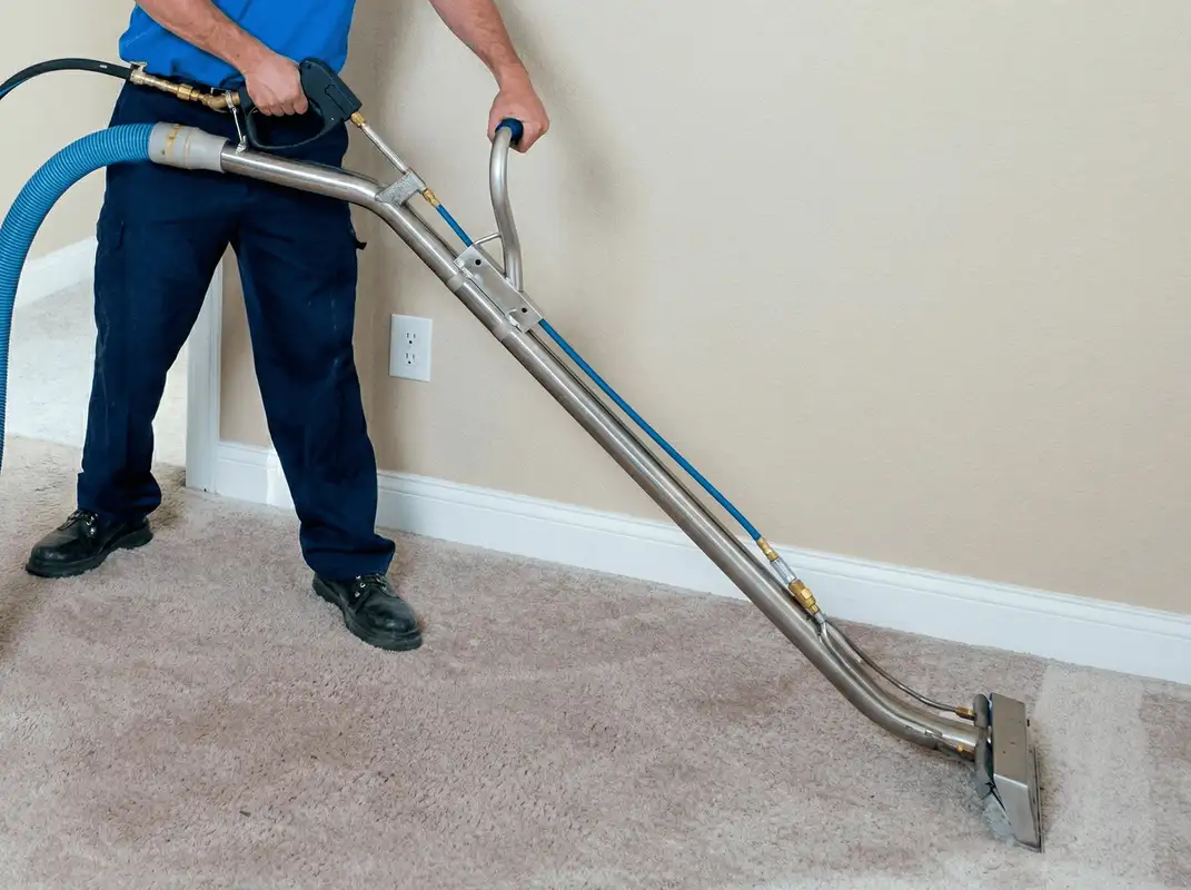Professional operating a liquid removal machine on a carpeted floor in Baton Rouge, LA